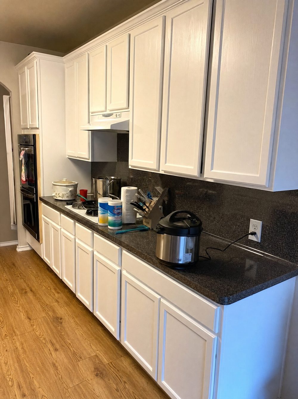 The same kitchen finished: crisp white cabinets back in daily use