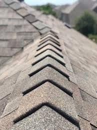 New ridge cap shingles on a completed roof